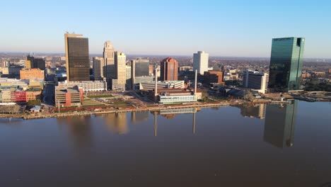 downtown toledo skyline with reflection on maumee river, ohio, usa