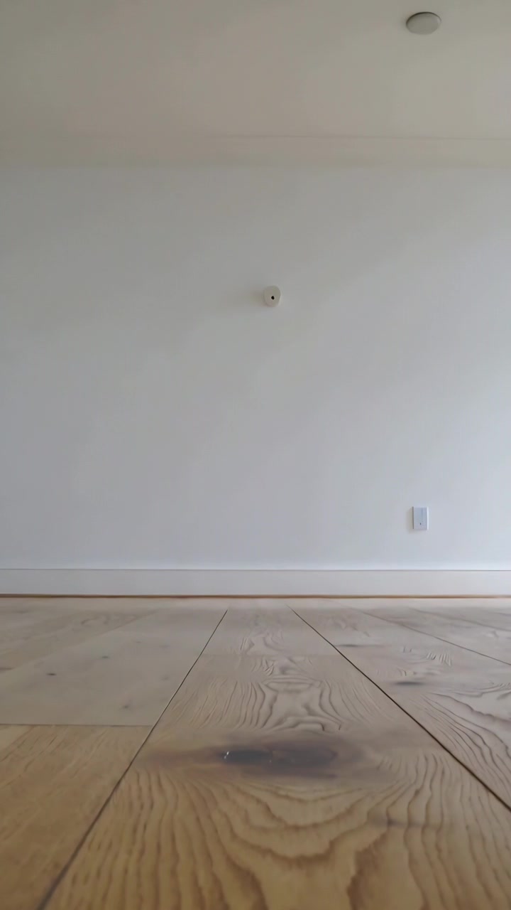 Vertical video: Recording starting low cam tilting to reveal knot, wall sensor and ceiling at home