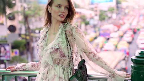 beautiful woman in a floral dress on a city walk