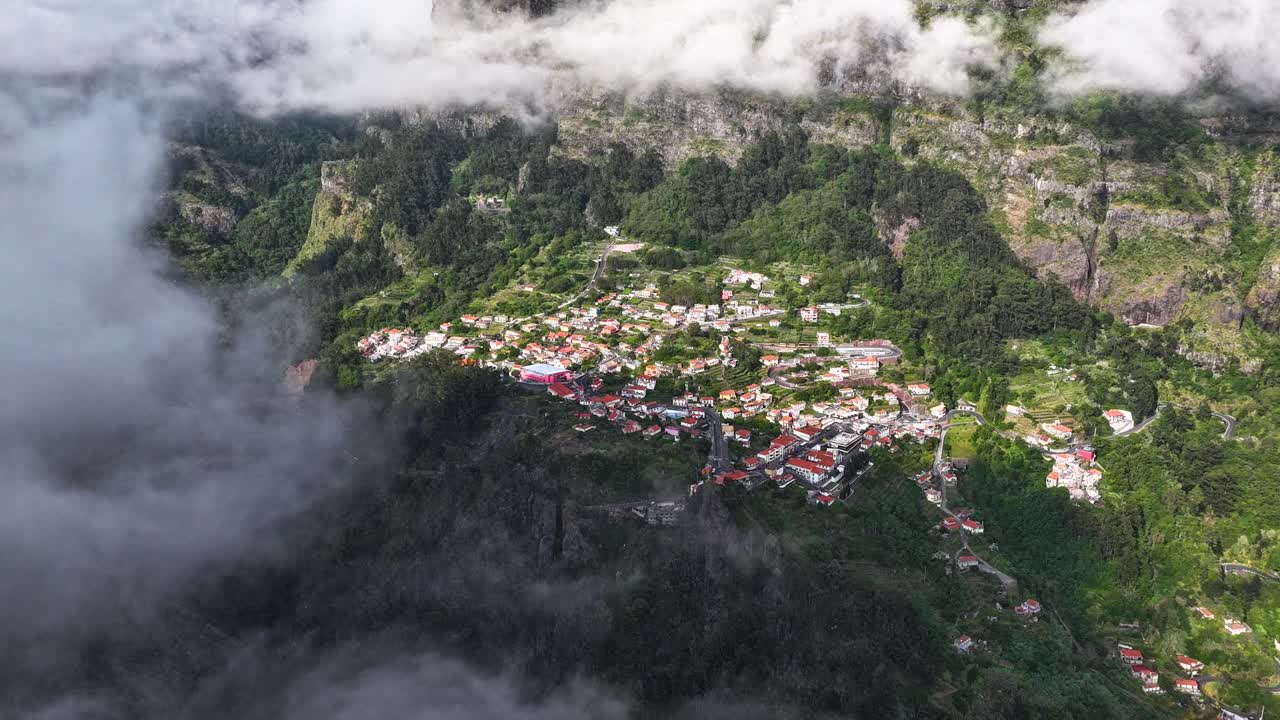 Drone time lapse of mountain fog moving over scenic Curral das Freiras parish