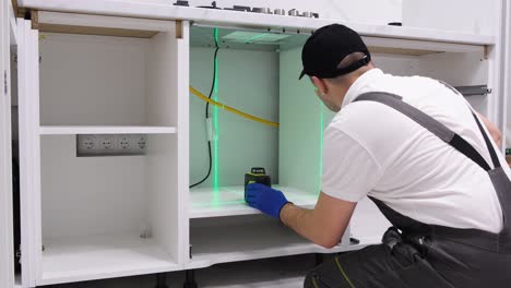 kitchen cabinets installation young male worker assembling furniture kitchen cabinets installation young male worker assembling furniture copy space