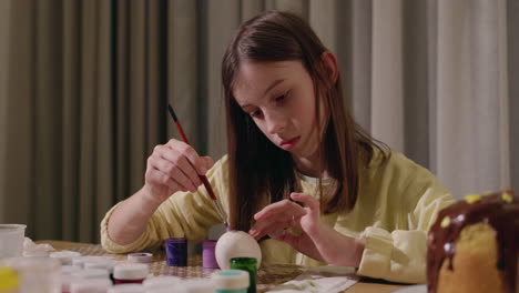 girl painting an easter egg