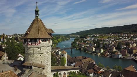 aerial dolly in of munot circular fortress on a hill revealing schaffhausen village and high rhine river, hills in background, switzerland