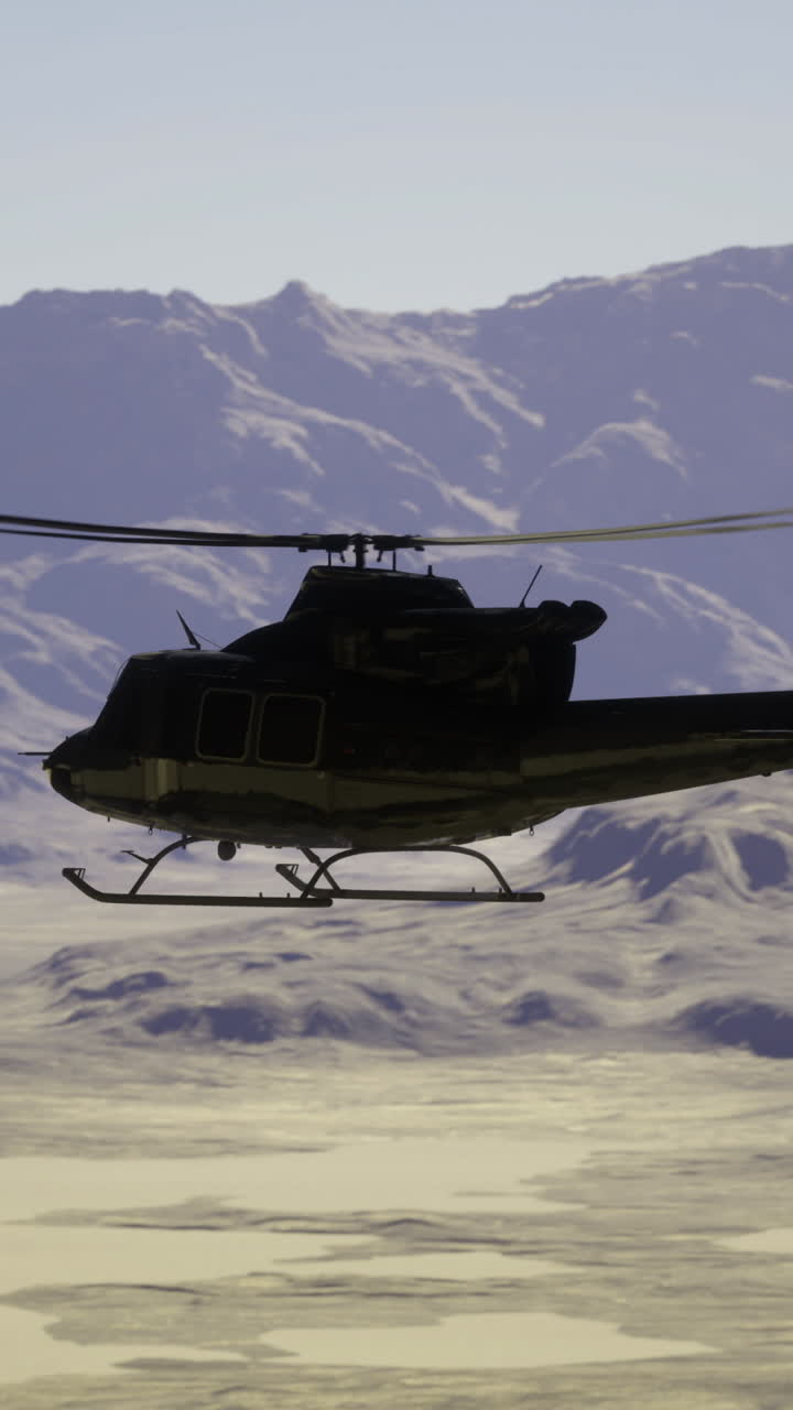 Helicopter flying over mountainous terrain in clear weather during daytime
