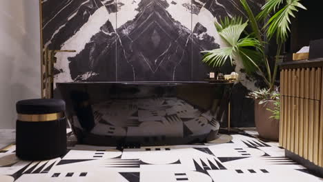 black bathtub against black and white abstract mountain marble wall pattern