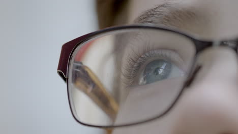 Closeup-on-a-boy's-blue-eye-with-glasses-as-he-looks-up-towards-the-sky