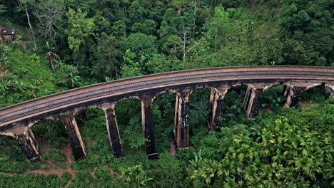 stunning aerial drone footage of the famous nine arches bridge in ella, sri lanka.