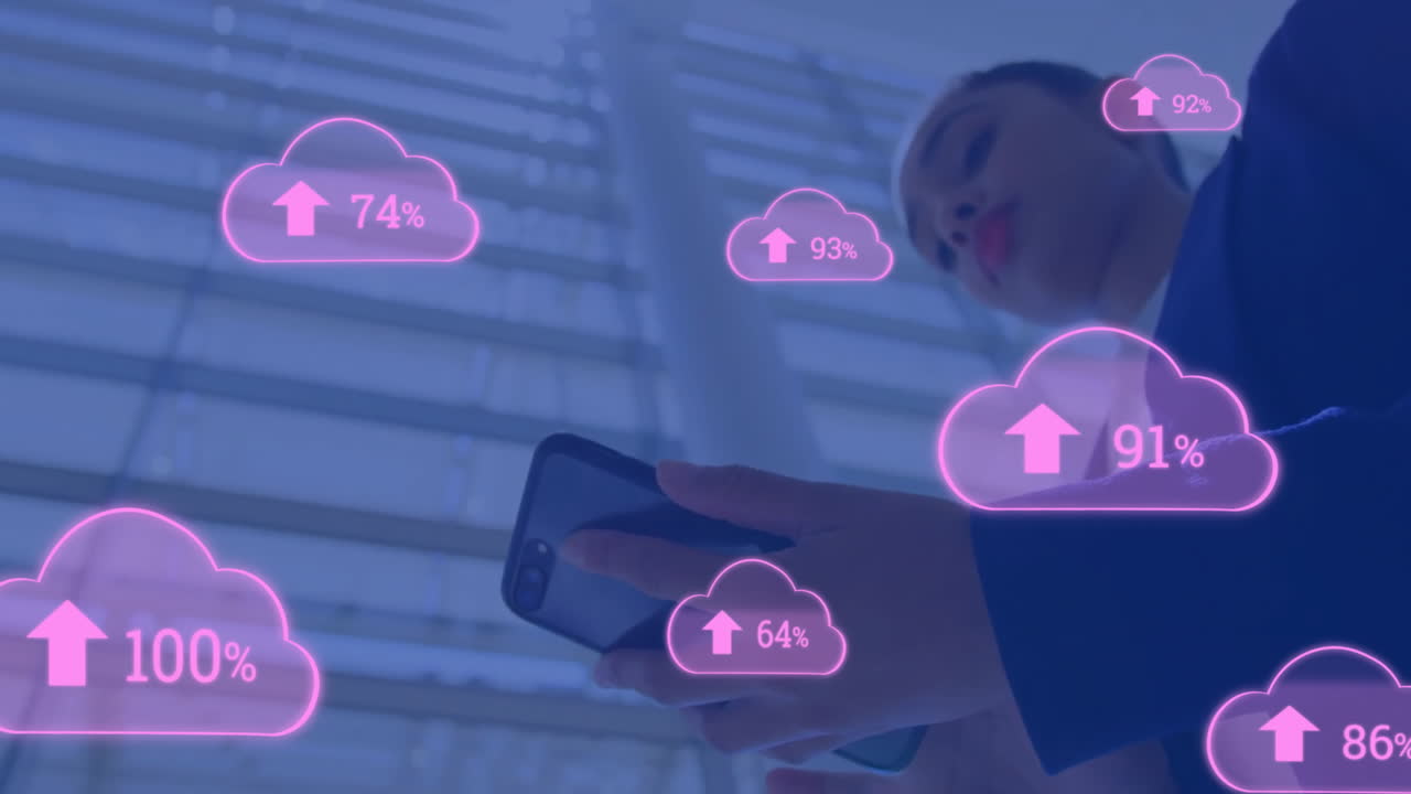 Animation of cloud icons with growing number over biracial businesswoman using smartphone