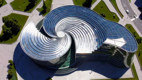 aerial view of a spiral modern office building in a city park