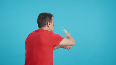 rear view of a man waving a begian pennant