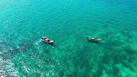 two longtail boats on turquoise water
