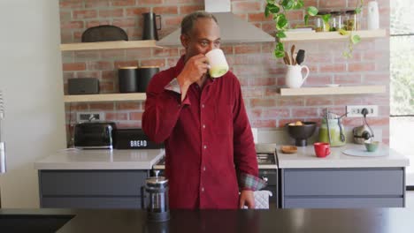 Senior-African-American-man-drinking-a-beverage-at-home