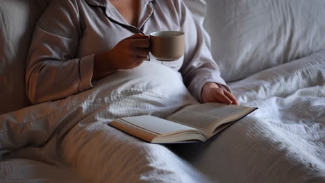 woman reading in bed with coffee