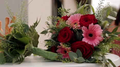 two bouquets placed on the table engagement and wedding bouquet