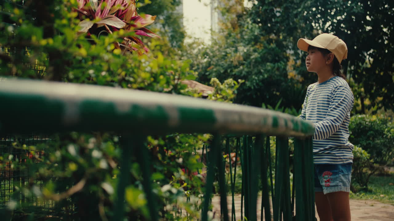 Girl watching animals at a zoo, thoughtful and calm, daytime outdoors, sunny mood