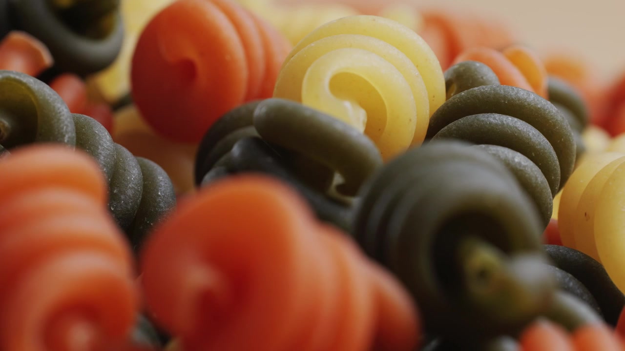 Tricolor Spiral Pasta Falling in Slow Motion
