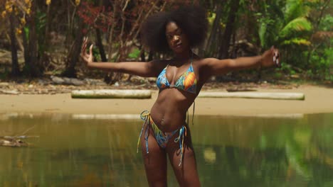 a bikini-clad girl with curly hair relishes the beauty of a sunny day on a tropical caribbean island beach