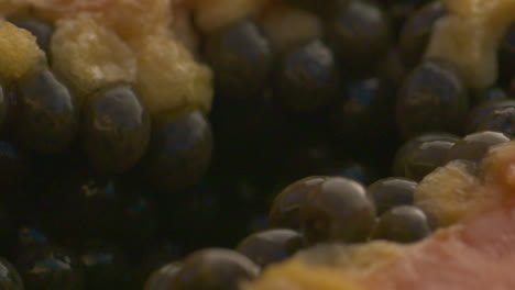 macro close up of papaya seeds inside a juicy, ripe fruit