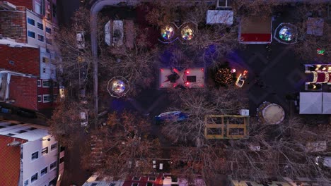 aerial view of cozy festive scene with a christmas tree, lights, and a warm small-town atmosphere