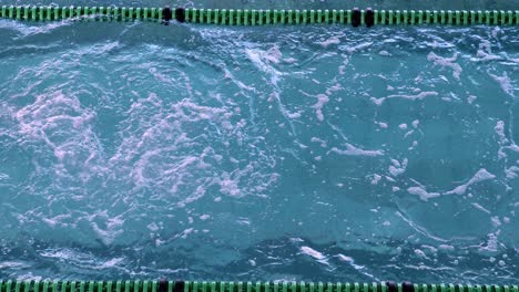 fit female swimmer doing the front stroke in the swimming pool