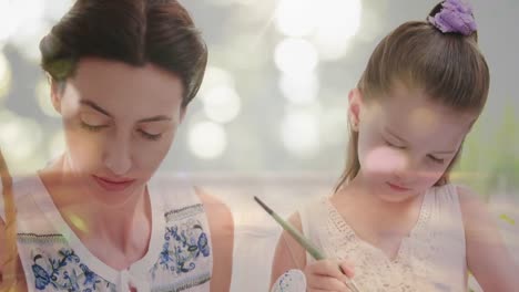 Animation-of-mother-and-daughter-decorating-Easter-eggs-