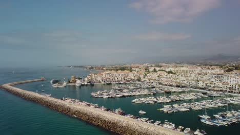 puerto banus marina in marbella with boats and coastline, sunny day, aerial view