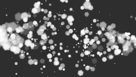 Motion-white-glitters-and-hexagons-bokeh-on-black-background