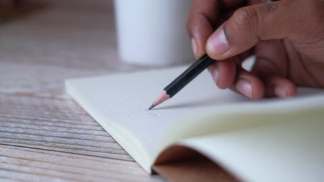 person writing in a notebook