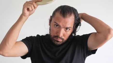 man using brush on his head with baldness, paddle brush, latino man, hair