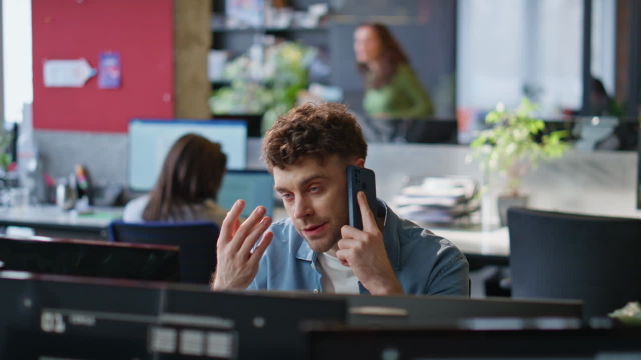Worried employee calling cellphone at workplace closeup. Upset manager talking
