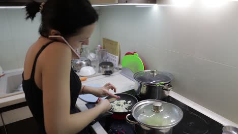 Beautiful-caucasian-woman-talking-on-the-phone-while-cooking