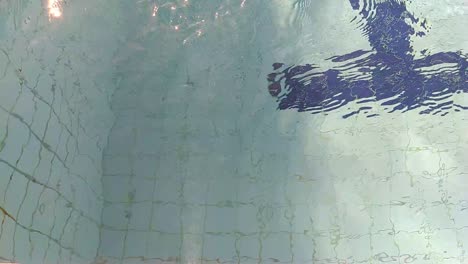 blue swimming pool with a strong water jet