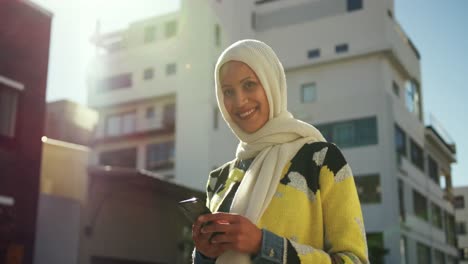 young woman wearing hijab out and about in the city