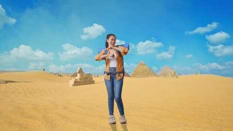 full body of asian female hiker with mountaineering backpack enjoy dancing while traveling in pyramid of giza