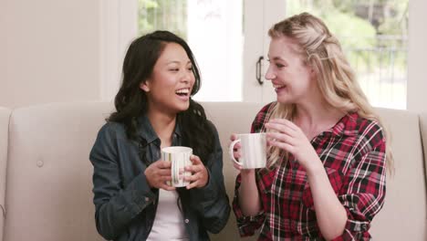 two female friends drinking coffee