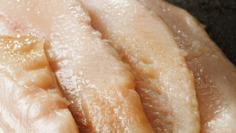close-up of raw fish fillet slices