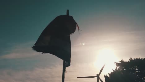 Broken-flag-of-Tarifa,-Spain,-in-4K,-denoised-and-slow-motion-during-sunset