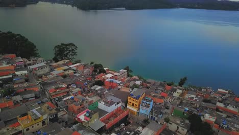 Aerial-birds-eye-view-flying-away-from-the-water-reserve-lake-in-Sao-Paulo