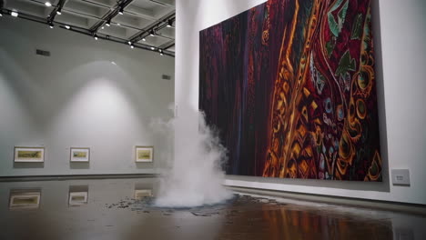 art gallery installation with abstract painting and smoke