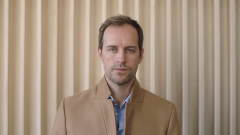 portrait of attractive casual businessman looking serious intense at camera focused male entrepreneur