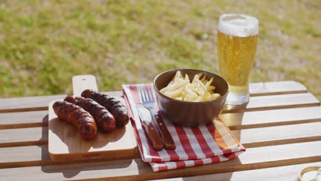 three tasty smoked grilled sausages with chips