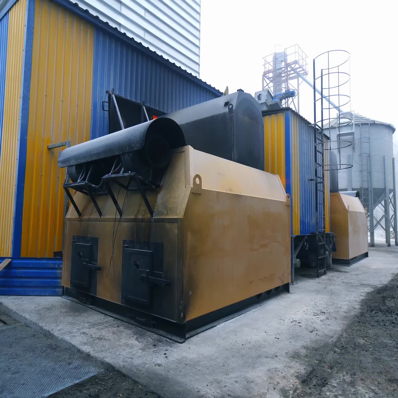 Diverse premises for storage and processing crops at large agricultural plant. Exterior of factory on processing grain crops