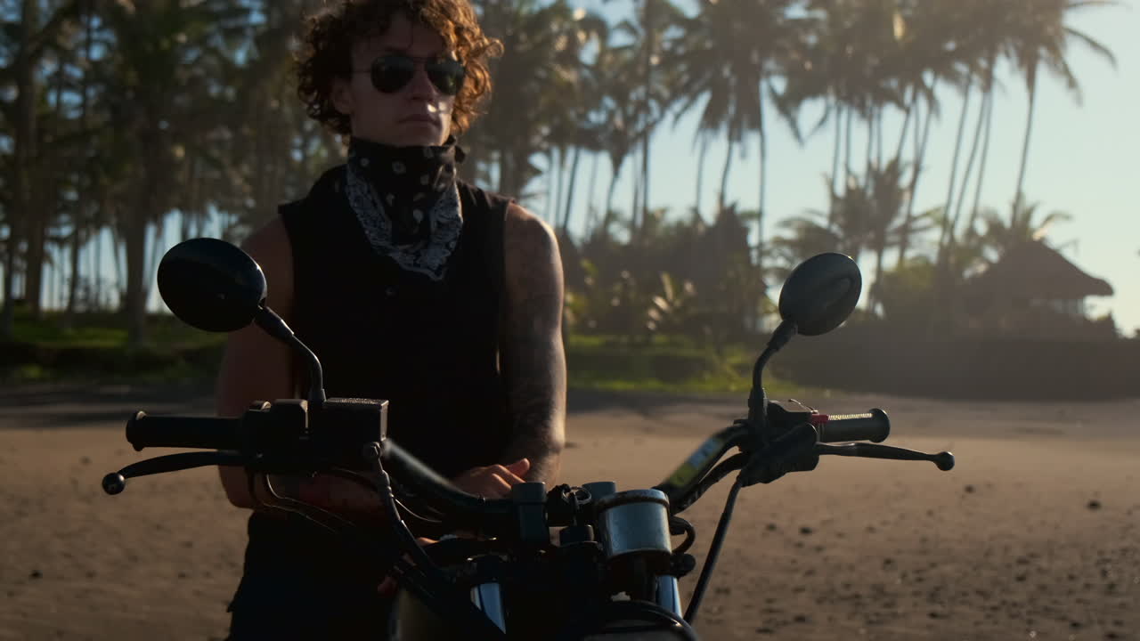Man on Motorcycle at Tropical Beach