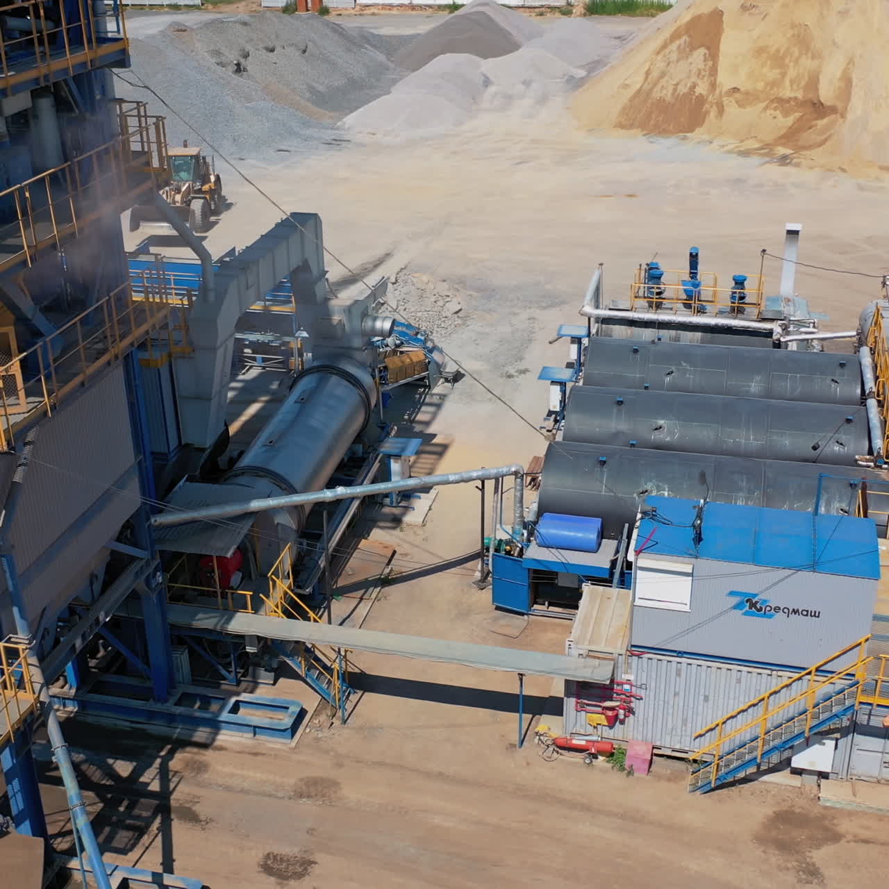Exterior of a modern asphalt plant. Storage bunker for products and raw materials in cement concrete plant. Industrial territory of a plant. Aerial view.