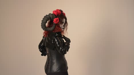 catrina cosplay girl turned back walking away from slowly with domina outfit and light background, medium shot