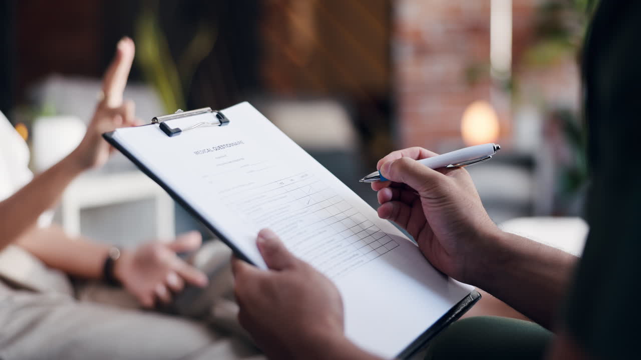Person's Hands Filling Out a Medical Questionnaire on a Clipboard