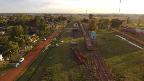 Aerial-view-of-rural-town-with-windmill-and-train-track