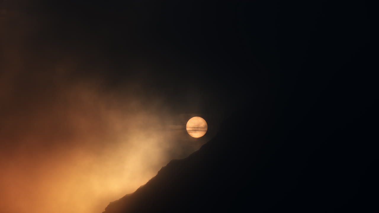 Sunrise/Sunset Through Clouds and Mountains