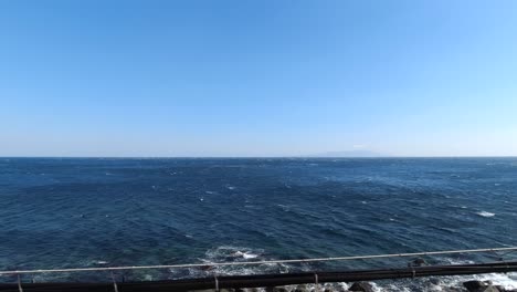 beautiful open sea passing by in slow motion from window view of car