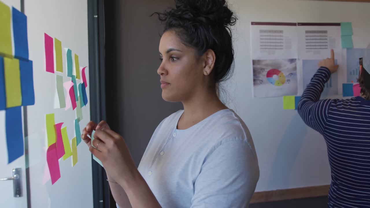 Mixed race woman working in creative office